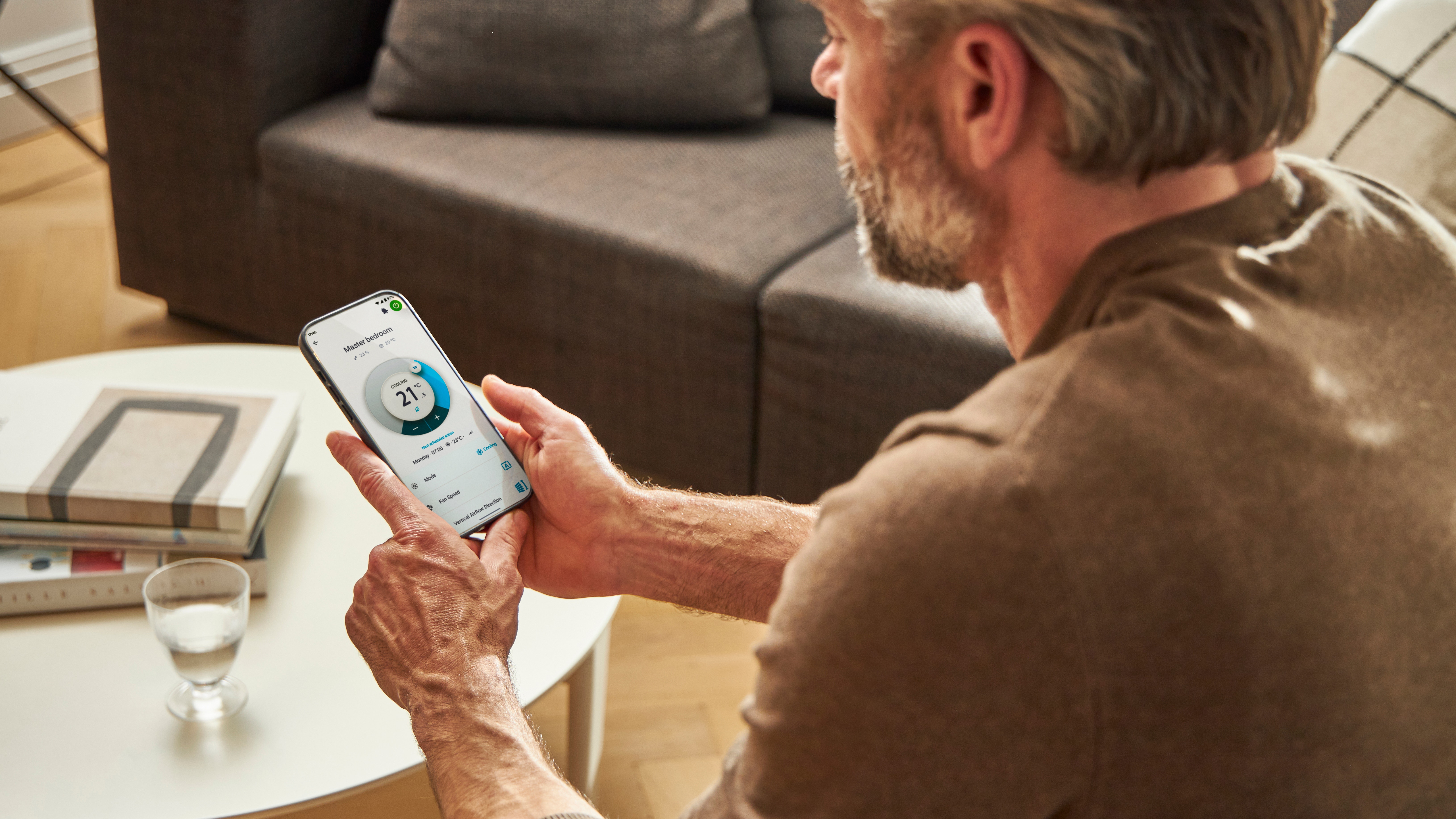 Man using an app to control his heating solution