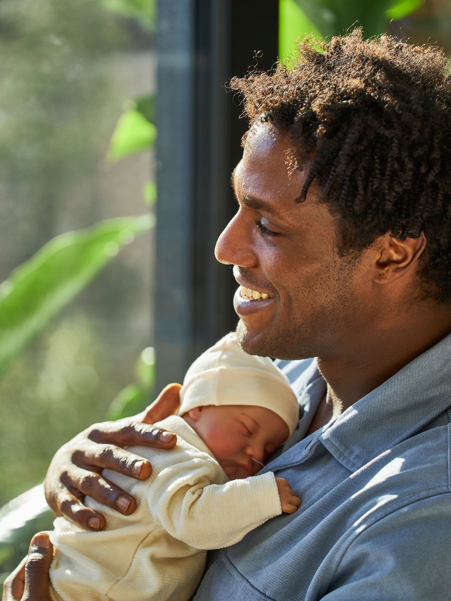 Man holding sleeping baby