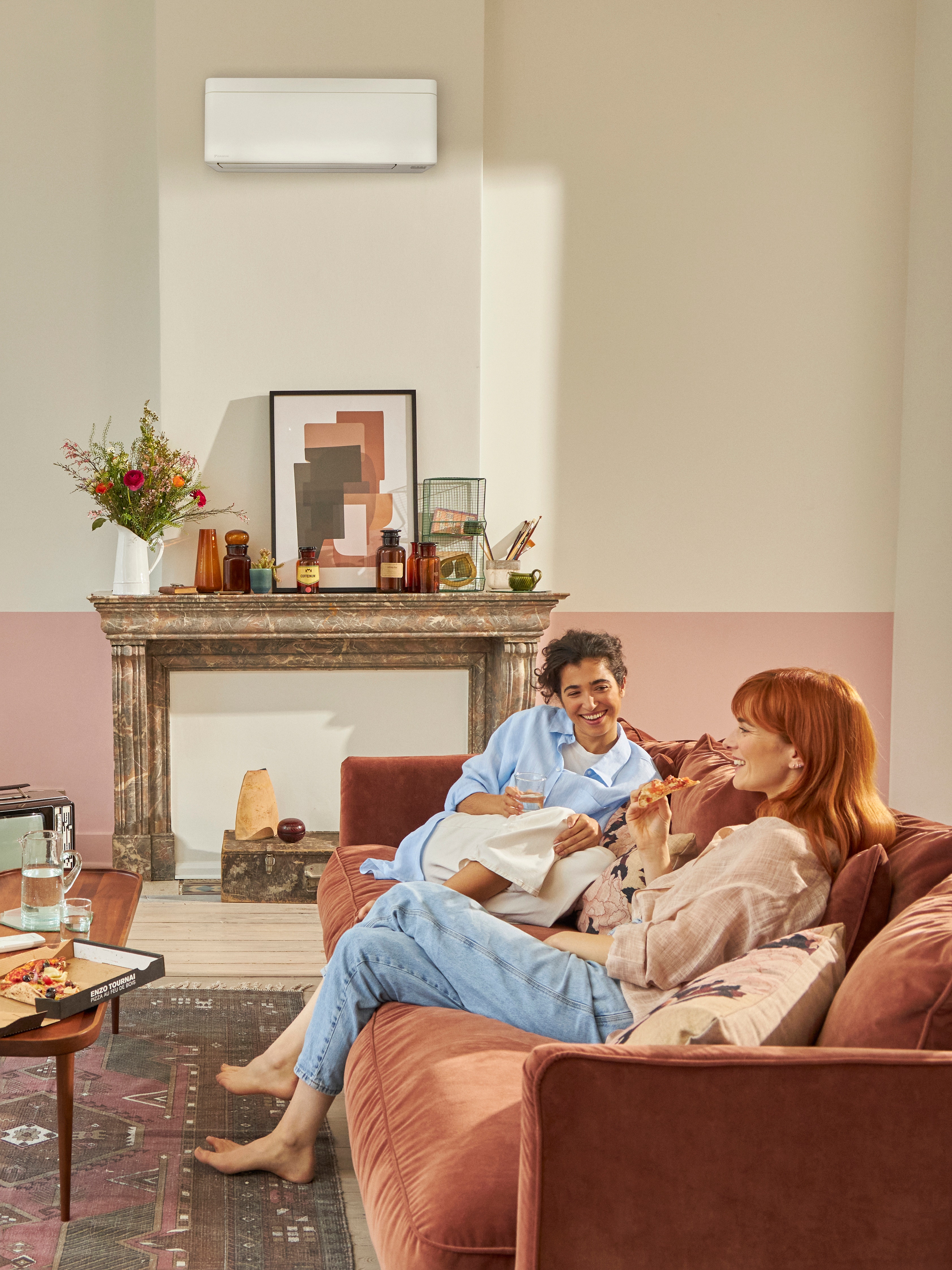 Woman on the phone while sitting in her living room enjoying cool air from heat pump