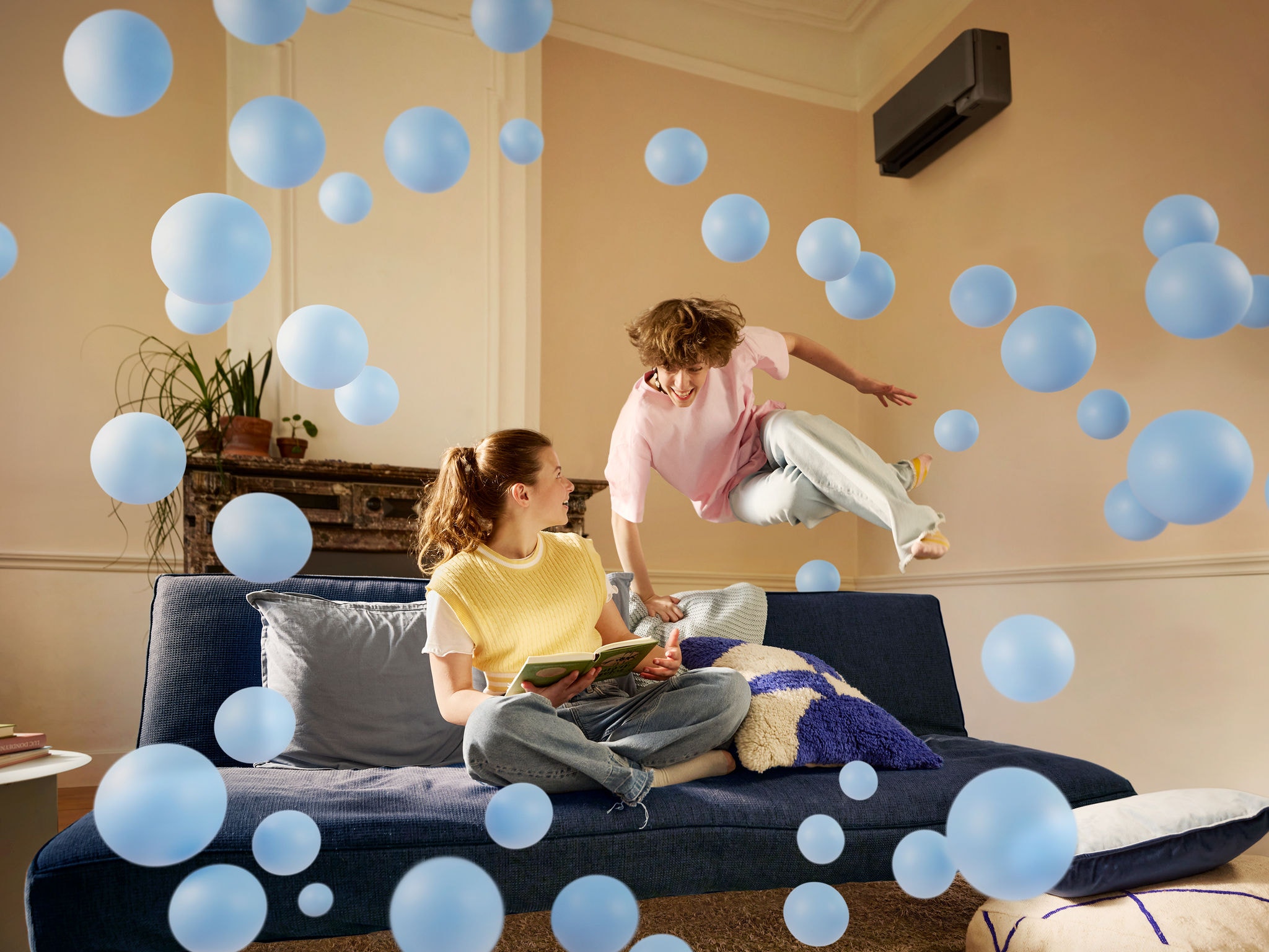 mother and baby in room with Perfera air conditioner