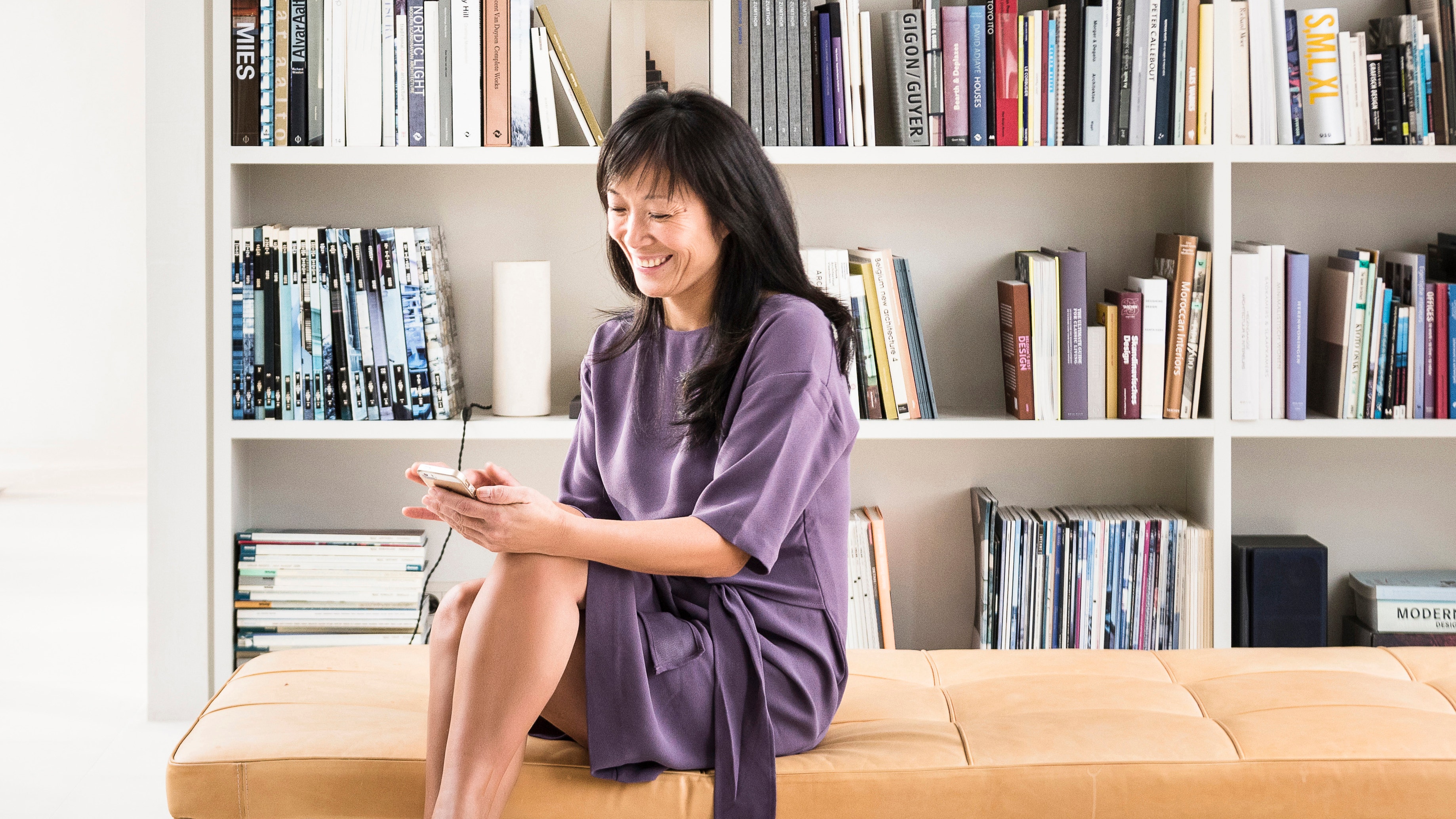 Woman using the Onecta app to control heating, cooling, and hot water of her home