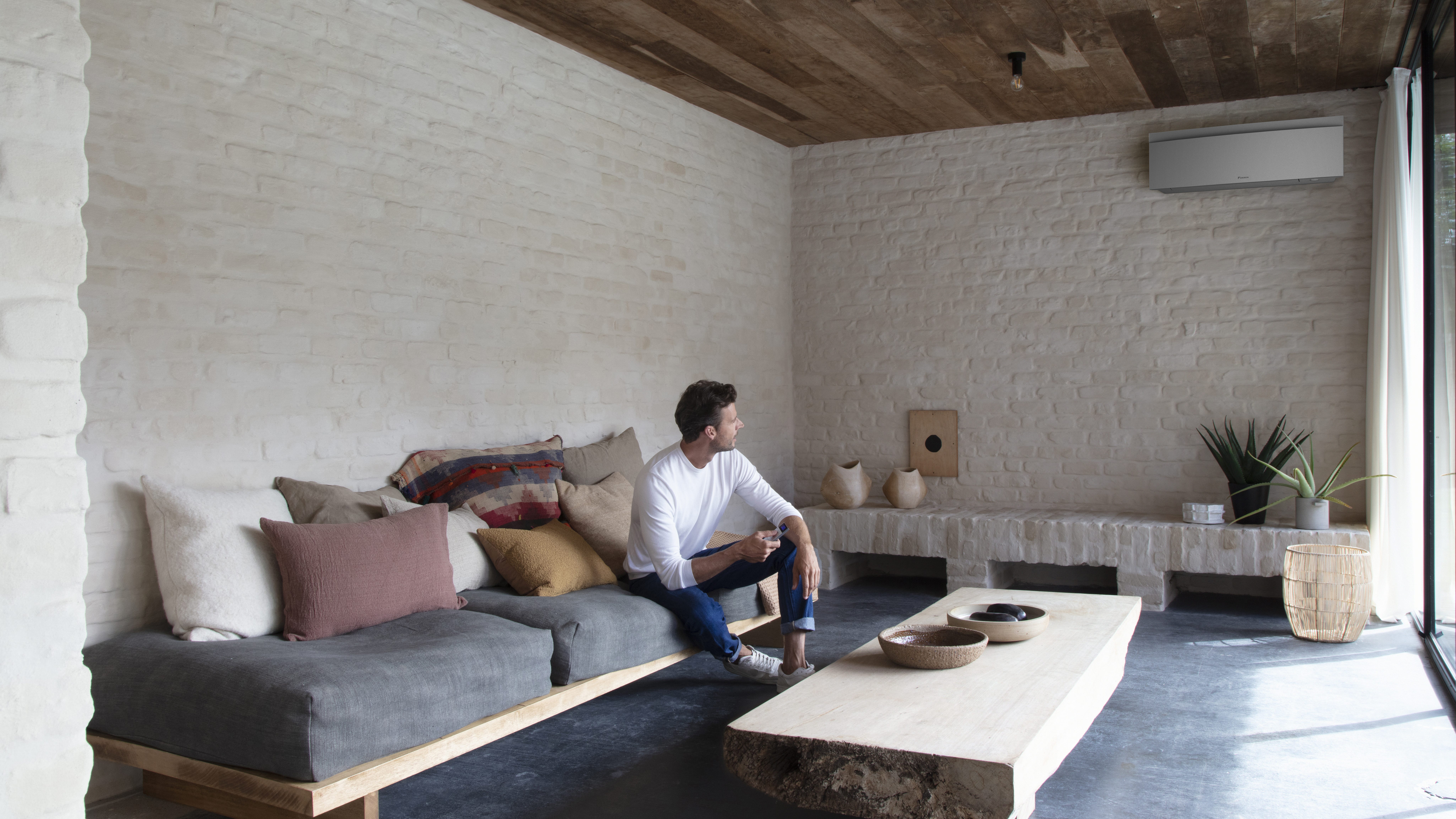 Installer putting a Stylish indoor unit on the wall