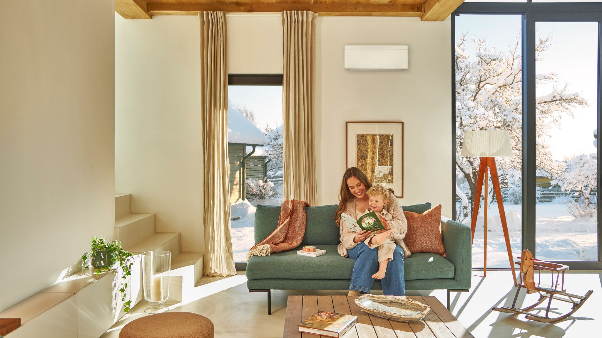 Mother and child enjoying heating with an air conditioner